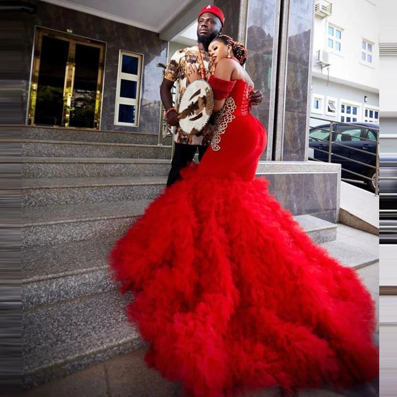 Back view of a red mermaid prom dress showcasing tale.