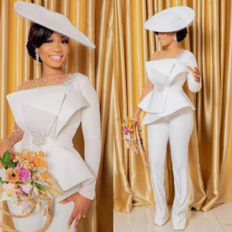 White beaded peplum suit with sparkling embellishments and matching hat, ideal for weddings, receptions, and elegant formal occasions.