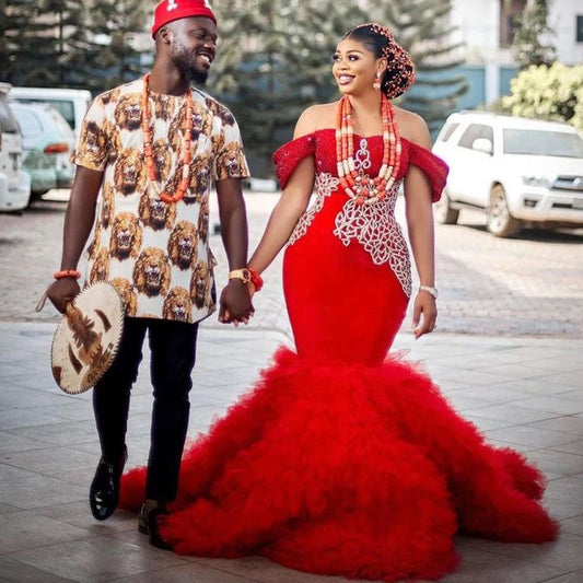 Front view of a stunning red mermaid prom dress with intricate beadwork